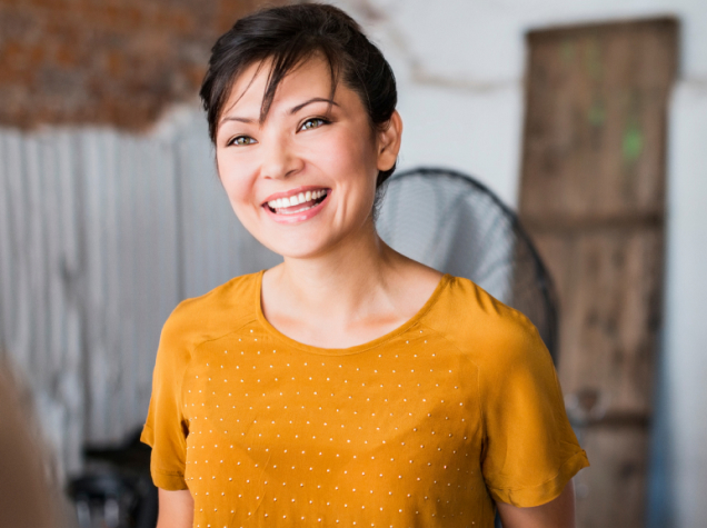 Smiling woman in yellow shirt