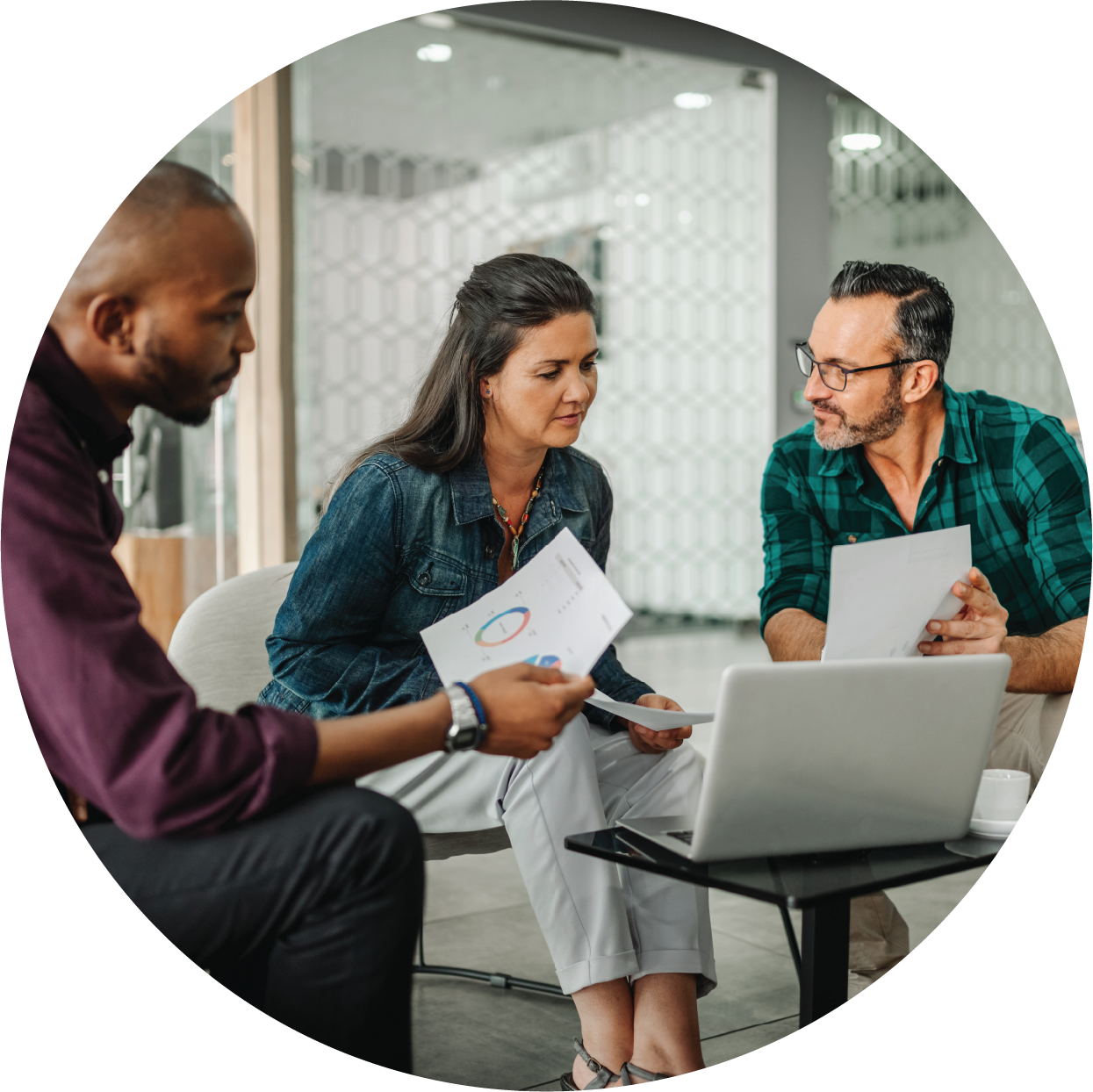 Three business professionals are going over investment data insights.